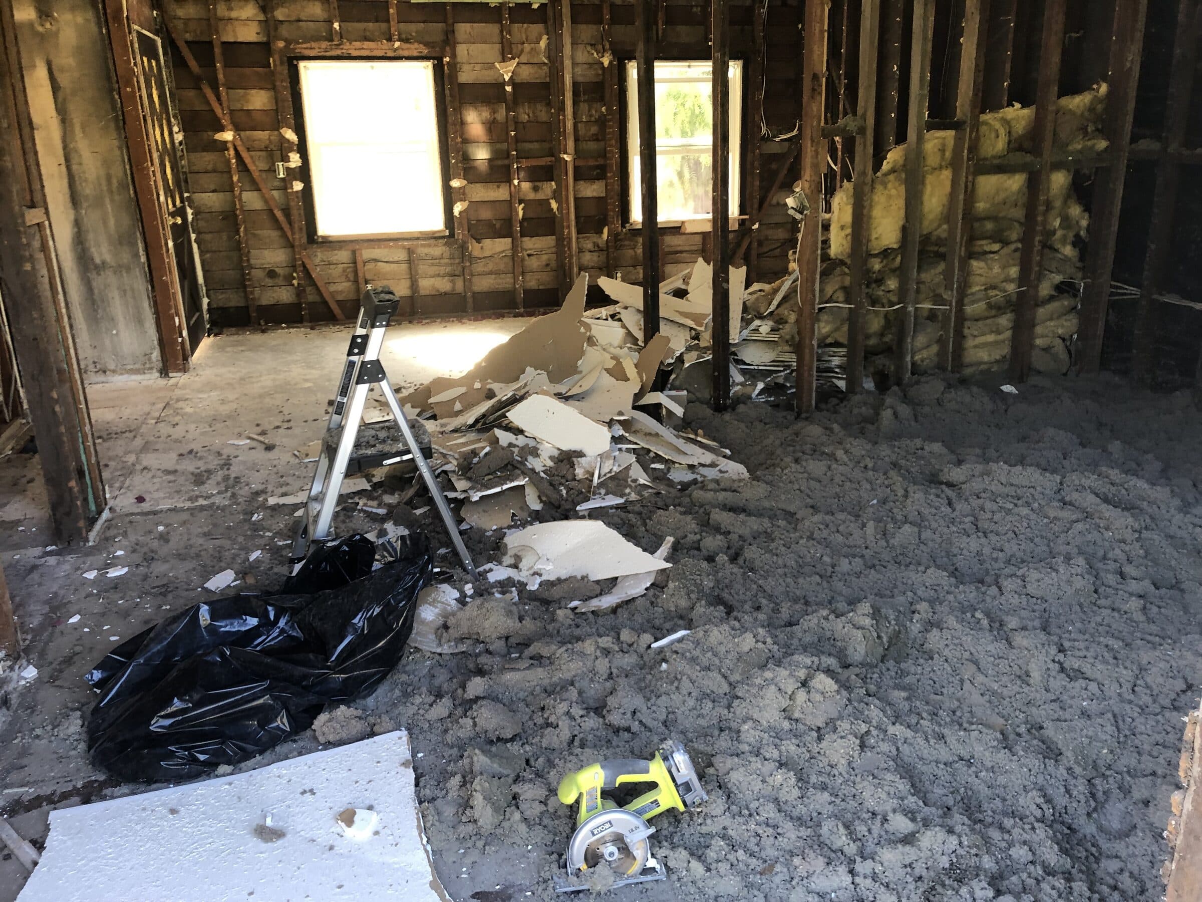 Interior gutted to the studs during demolition, debris and old framing exposed